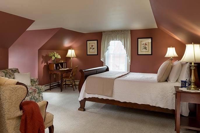 Sleigh bed in room at a NH Getaways Inn